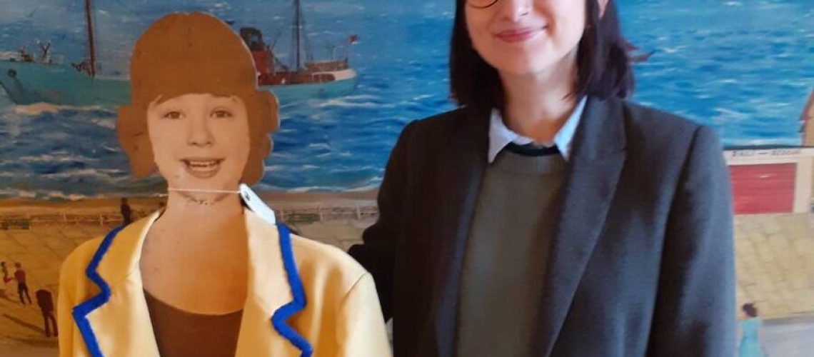Collections Assistant Zara Robinson with 
 a cardboard cut out and usherette's jacket from the Victoria cinema building in Fleetwood.
